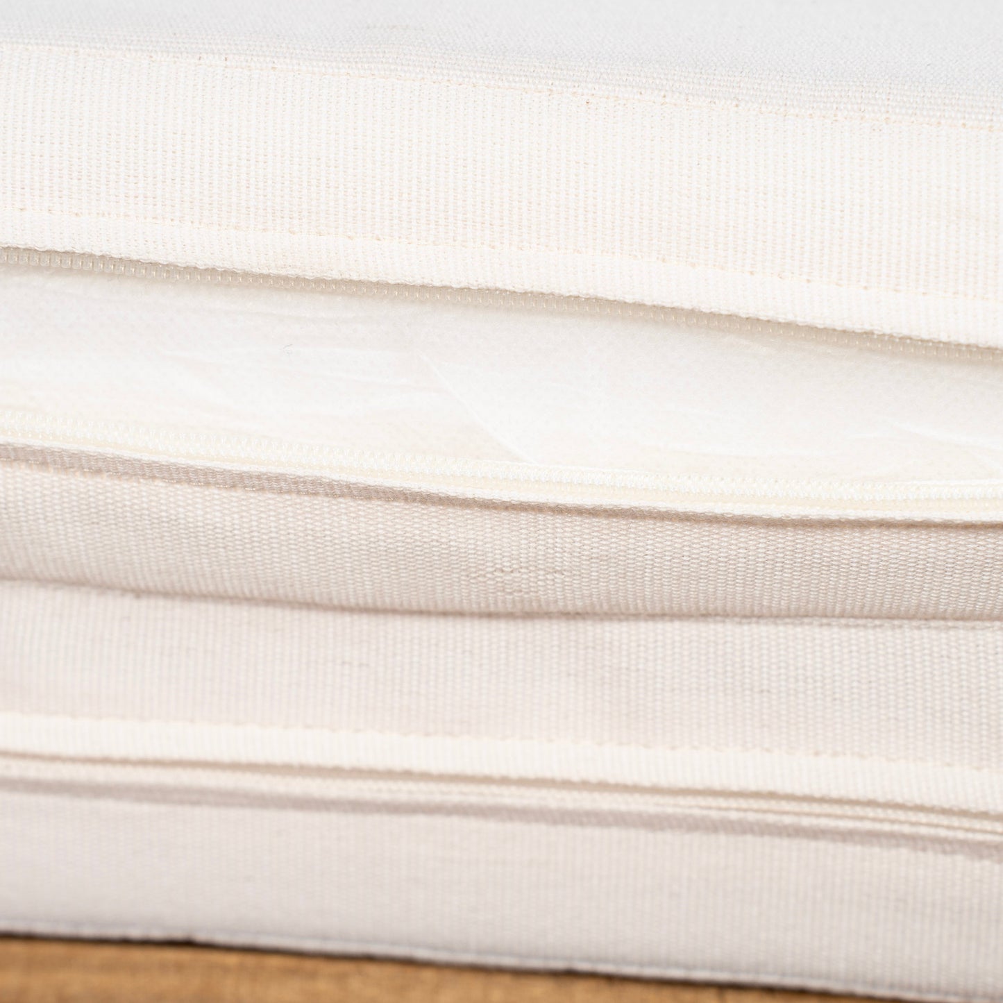 Sun lounger cushion fabric close-up in cream with woven texture on Tampa Home & Garden Store