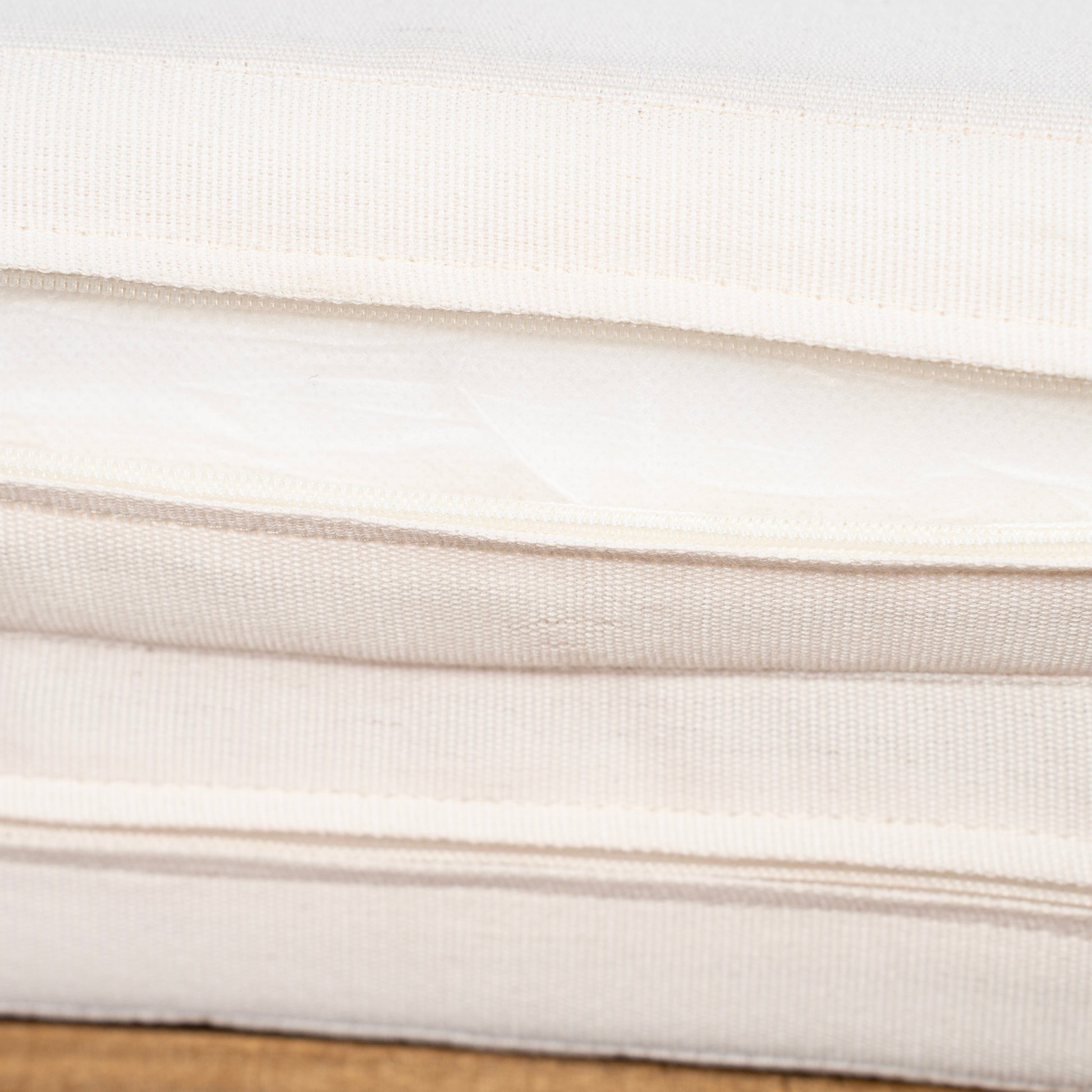 Sun lounger cushion fabric close-up in cream with woven texture on Tampa Home & Garden Store