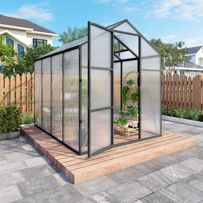 Windproof greenhouse with raised black base and polycarbonate panels in a backyard garden area on Tampa Home & Garden Store