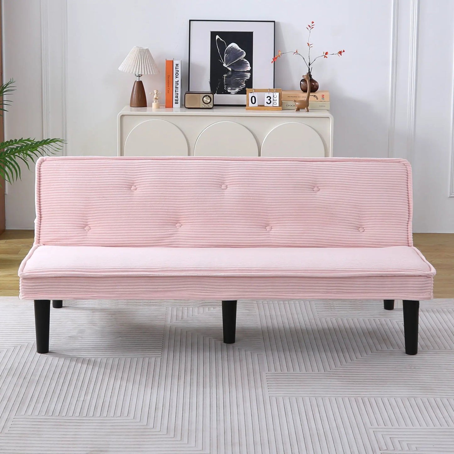 Versatile Sofa Bed with Solid Wood Frame in pink tufted fabric with dark tapered legs on Tampa Home & Garden Store
