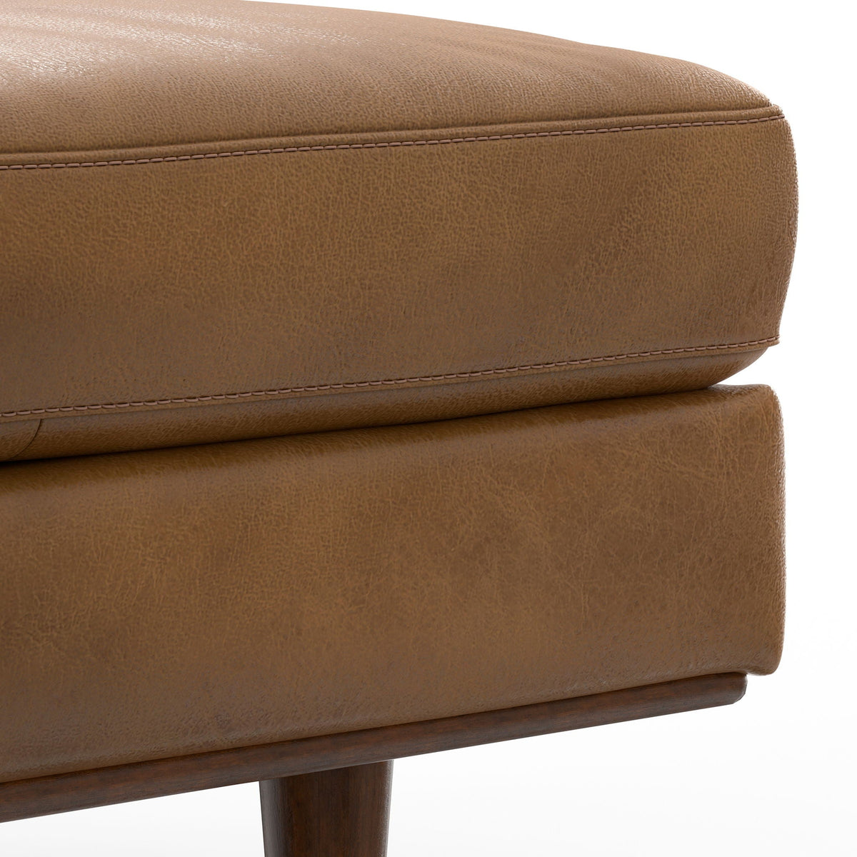 Morrison Handcrafted Leather Ottoman in tan pebble-textured finish with exposed wood leg on Tampa Home & Garden Store