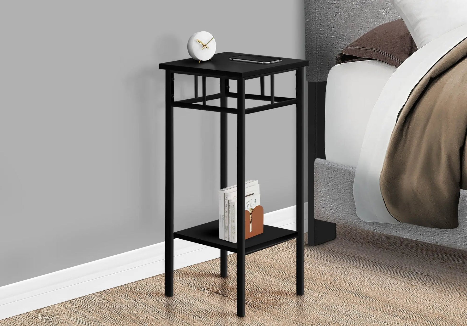 Accent Table with black metal frame; top clock and smartphone, bottom shelf with books on Tampa Home & Garden Store