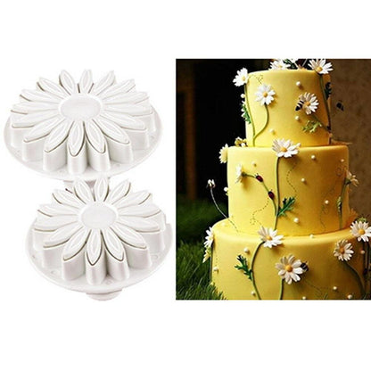 Stevvex fondant daisy cutters (2); white flower cookie molds beside a yellow cake with daisies on Tampa Home & Garden Store