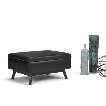 Owen upholstered rectangular storage ottoman in black with dark wood legs on Tampa Home & Garden Store