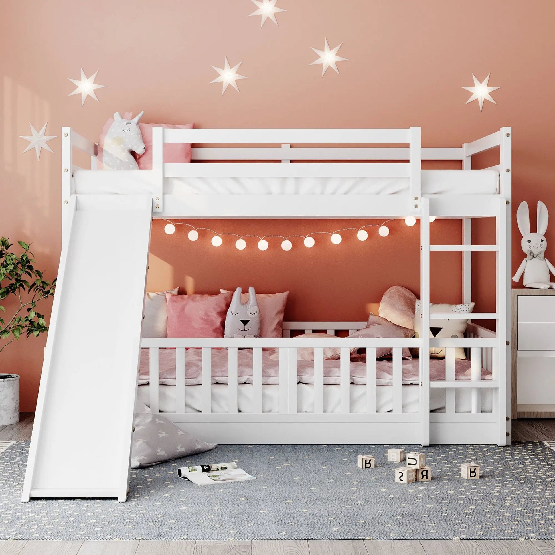 White bunk bed with slide and ladder in a pink kids room Unique Piece Furniture on Tampa Home & Garden Store