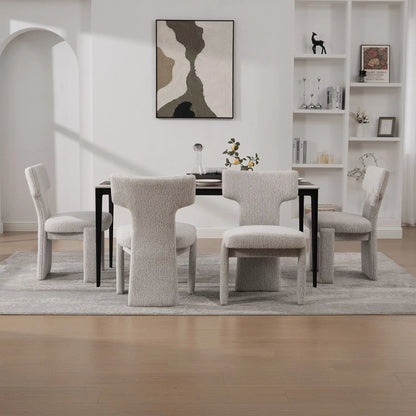 Armless curved-back accent chairs in light gray fabric with black legs around a dining table on Tampa Home & Garden Store