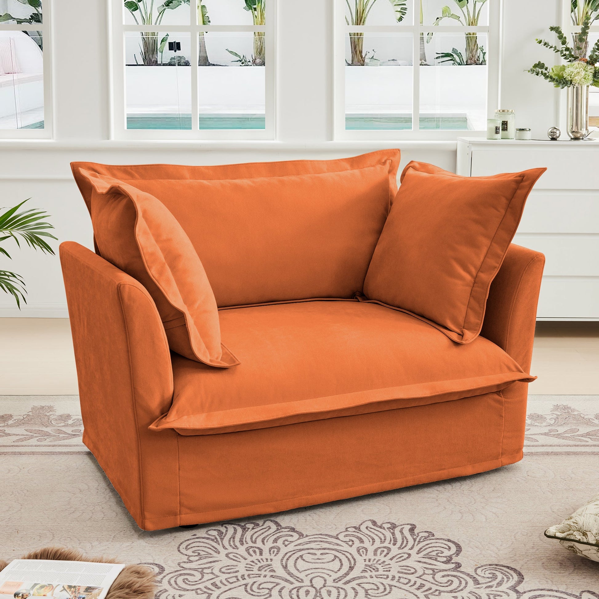 Slip-covered orange armchair with cushions in living room by white windows HouseOfZazla on Tampa Home & Garden Store