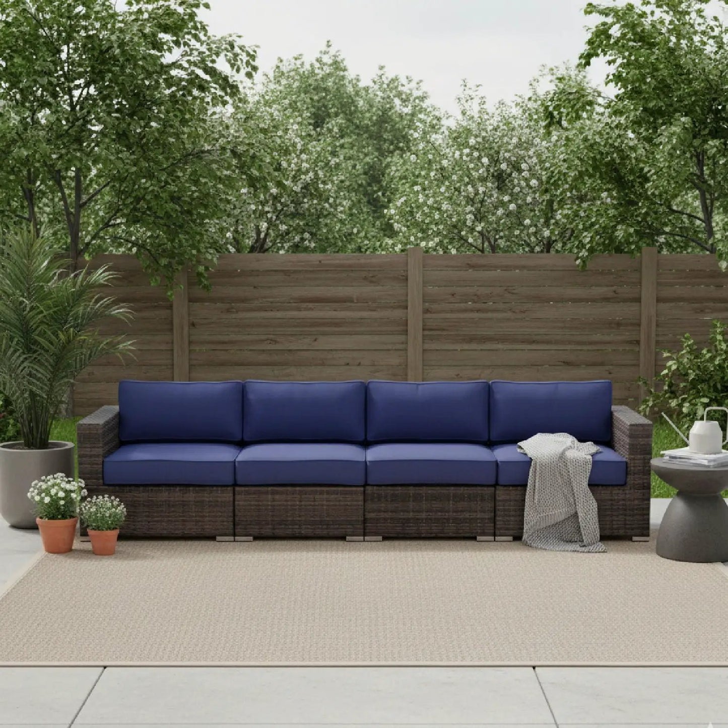Luxurious wicker patio sectional with blue Sunbrella cushions by Unique Piece Furniture on Tampa Home & Garden Store