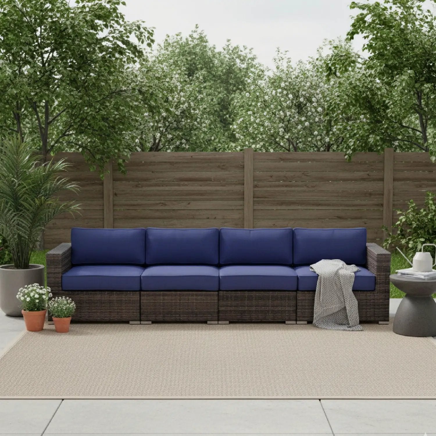 Luxurious wicker patio sectional with blue Sunbrella cushions by Unique Piece Furniture on Tampa Home & Garden Store