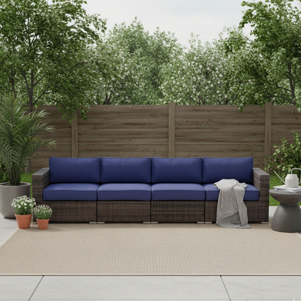 Luxurious wicker patio sectional with Sunbrella navy cushions by HouseOfZazla, stationary sofa on Tampa Home & Garden Store