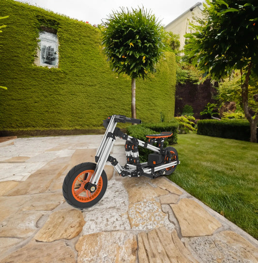 Modular electric kart frame with orange wheels and silver aluminum beams in a garden on Tampa Home & Garden Store