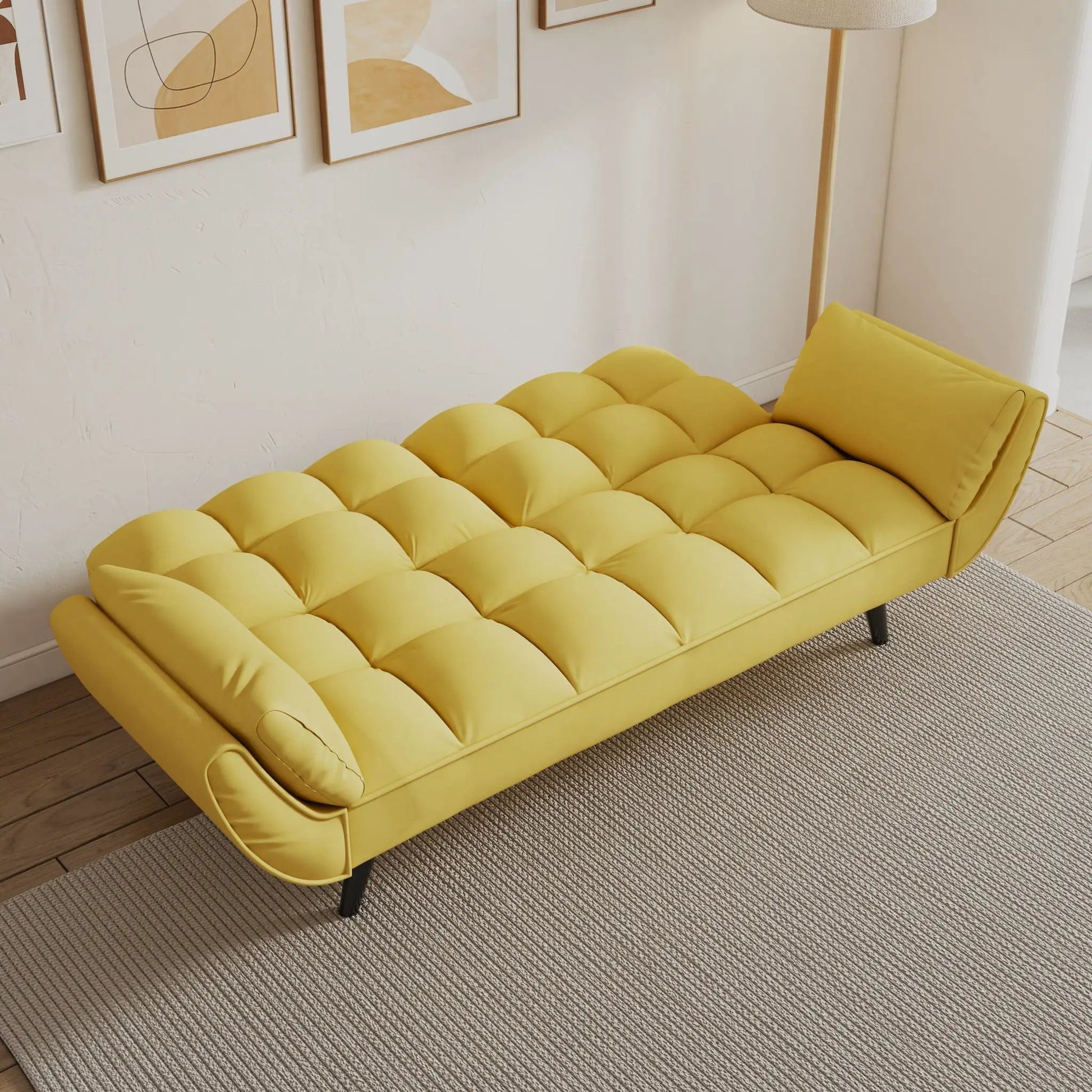 Yellow tufted futon sofa with two armrests and a matching pillow in a bright living space on Tampa Home & Garden Store