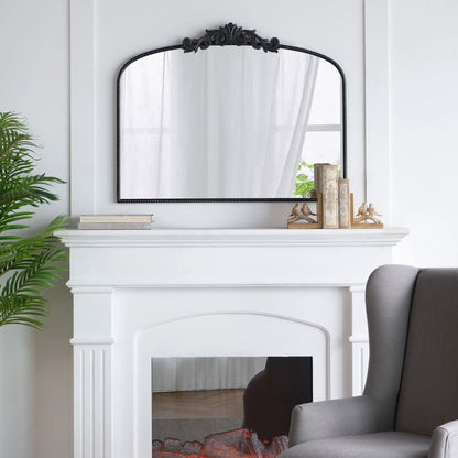 Arch mirror with ornate black Baroque-inspired metal frame on white mantel shelf on Tampa Home & Garden Store