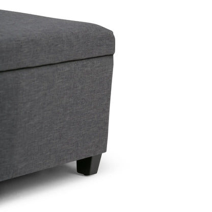 Avalon multifunctional storage ottoman bench in dark gray fabric with black wooden legs on Tampa Home & Garden Store