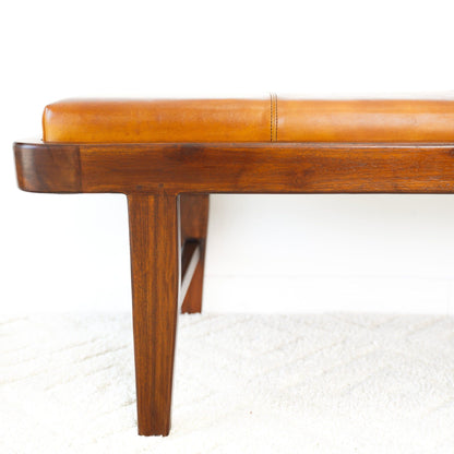Rustic upholstered bench with tan leather cushion and solid dark wood legs on Tampa Home & Garden Store