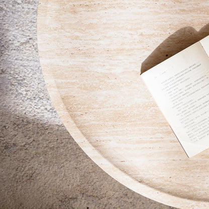 Round coffee table Mars pattern beige stone top with a partially visible book on edge on Tampa Home & Garden Store