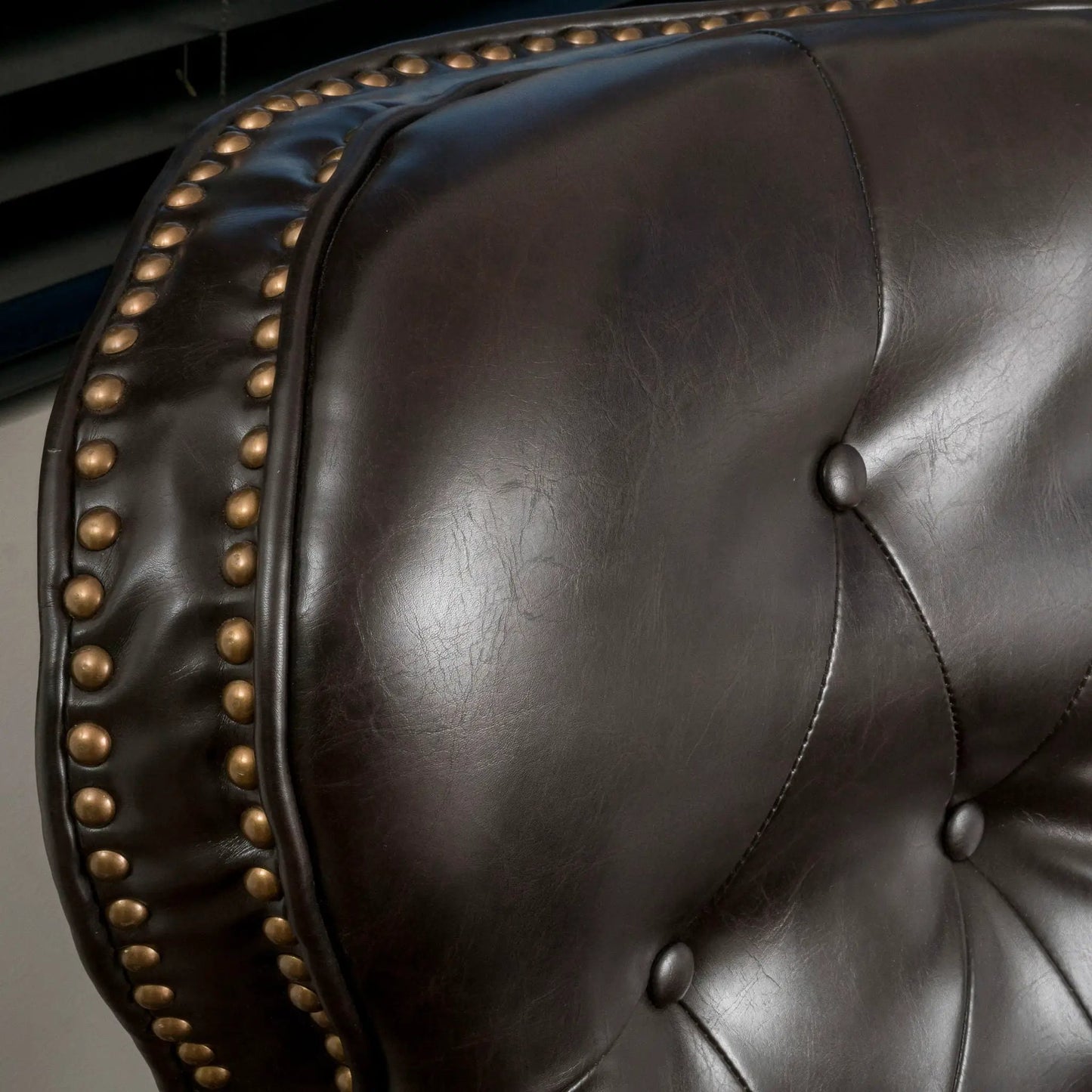 Contemporary push-back recliner in dark brown leather with brass nailhead trim and tufting on Tampa Home & Garden Store