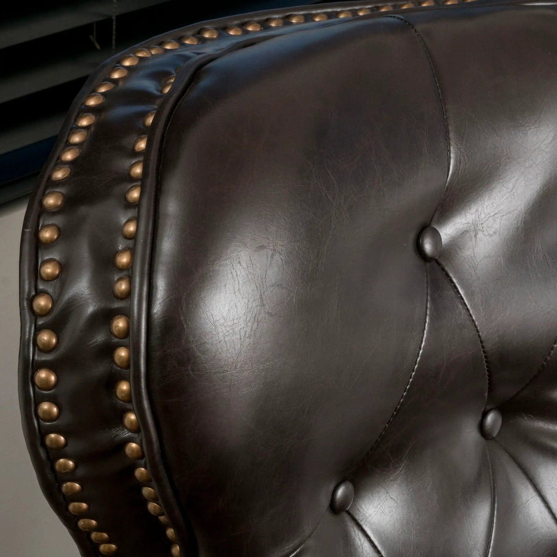 Contemporary push-back recliner in dark brown leather with brass nailhead trim and tufting on Tampa Home & Garden Store