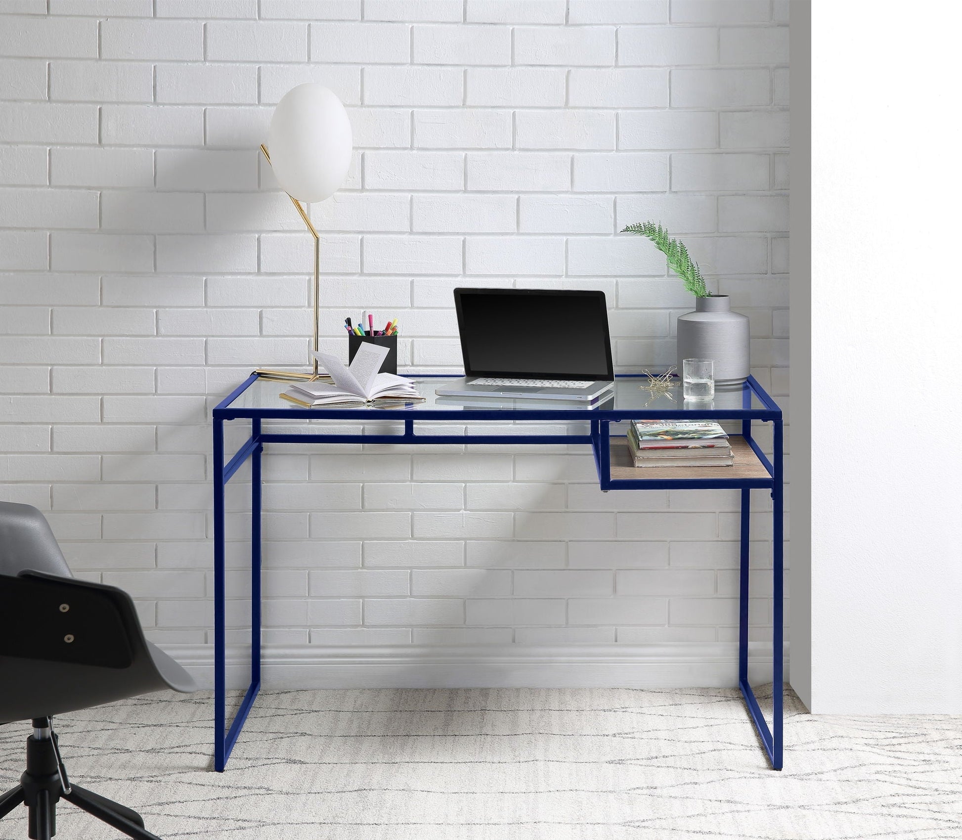 Yasin Glass Top Writing Desk blue metal frame with glass top laptop setup on brick wall on Tampa Home & Garden Store