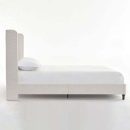 Harper tall headboard upholstered bed in light gray fabric with white linens on Tampa Home & Garden Store
