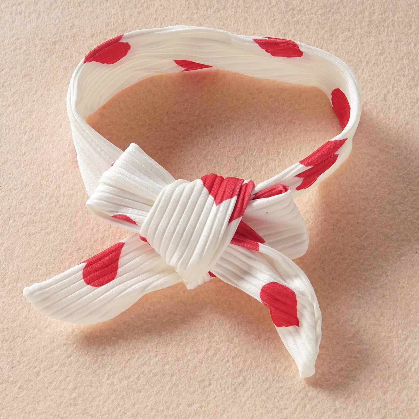 Infant white headband with red heart motif and knotted bow on Tampa Home & Garden Store