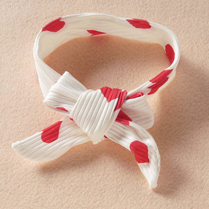 Infant white headband with red heart motif and knotted bow on Tampa Home & Garden Store