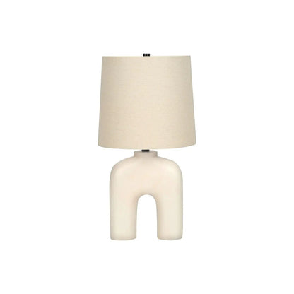 Table lamp with cream resin sculptural base and beige linen shade on Tampa Home & Garden Store