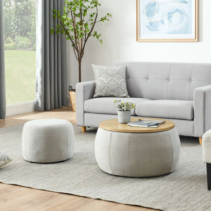 Round storage ottoman with wood-top end table in light gray fabric living room setup on Tampa Home & Garden Store