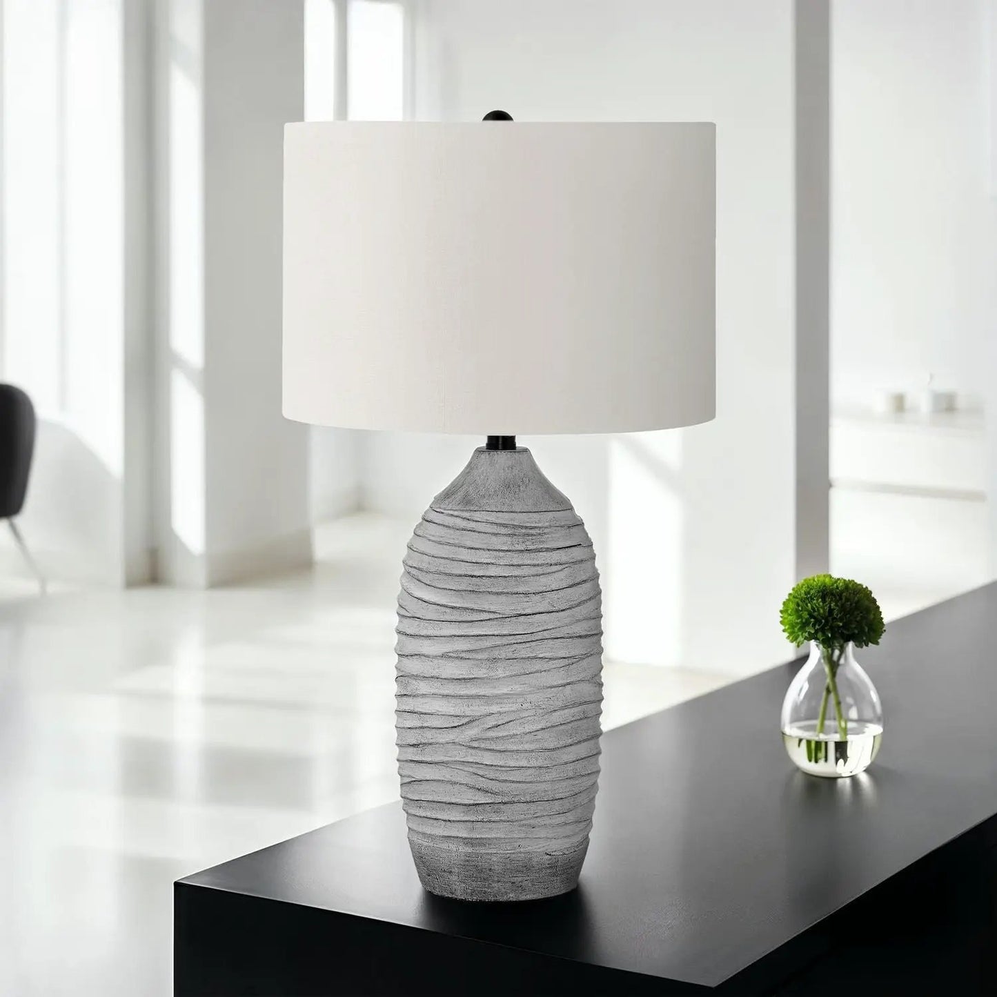 Table lamp with a ribbed gray resin base and cream fabric shade on Tampa Home & Garden Store