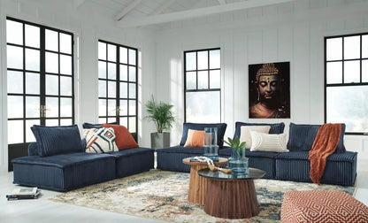 Bales Sectional stationary navy blue corduroy sofa with orange pillows in a bright living room on Tampa Home & Garden Store