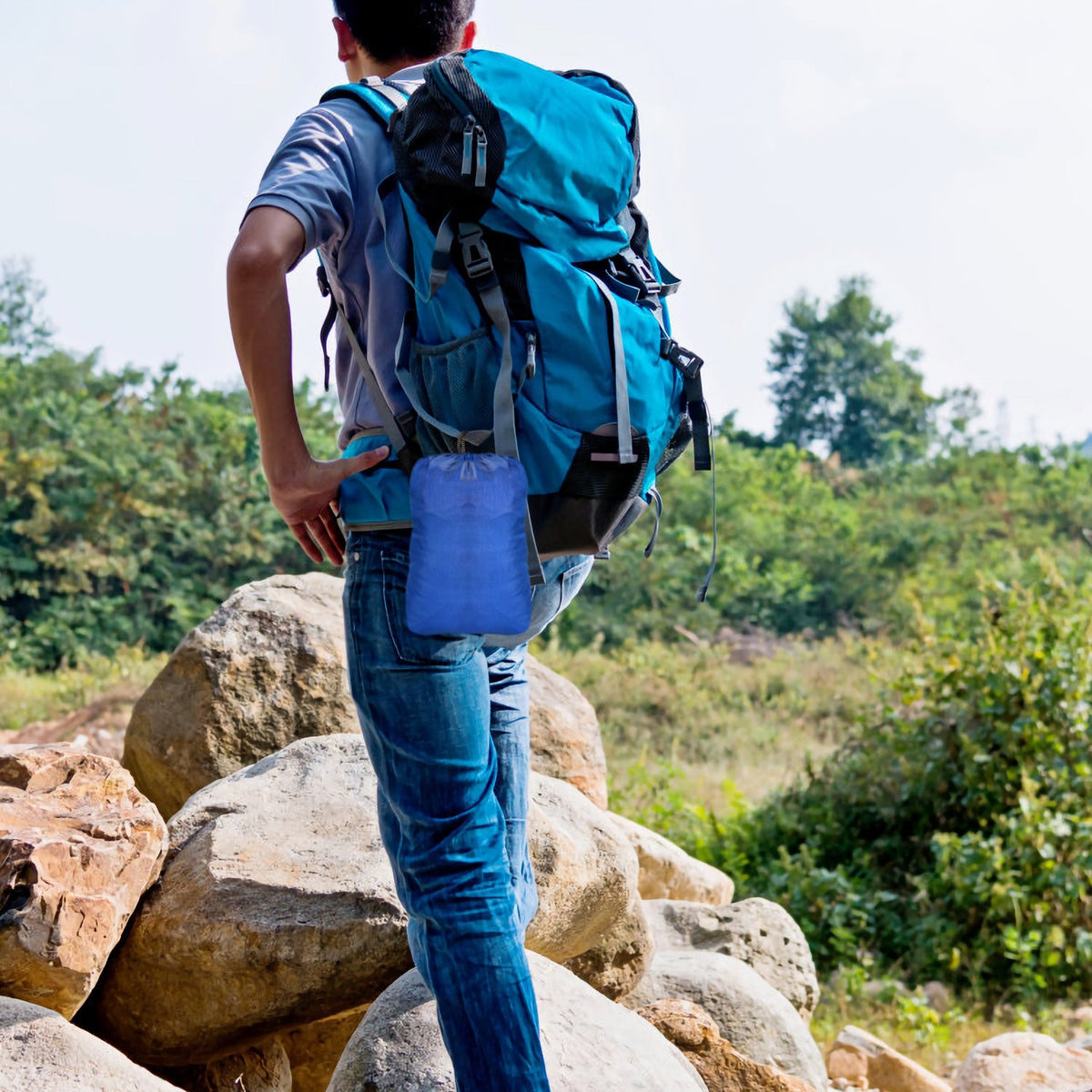 Blue GemGear hiking backpack with straps and side pocket on rocky trail on Tampa Home & Garden Store