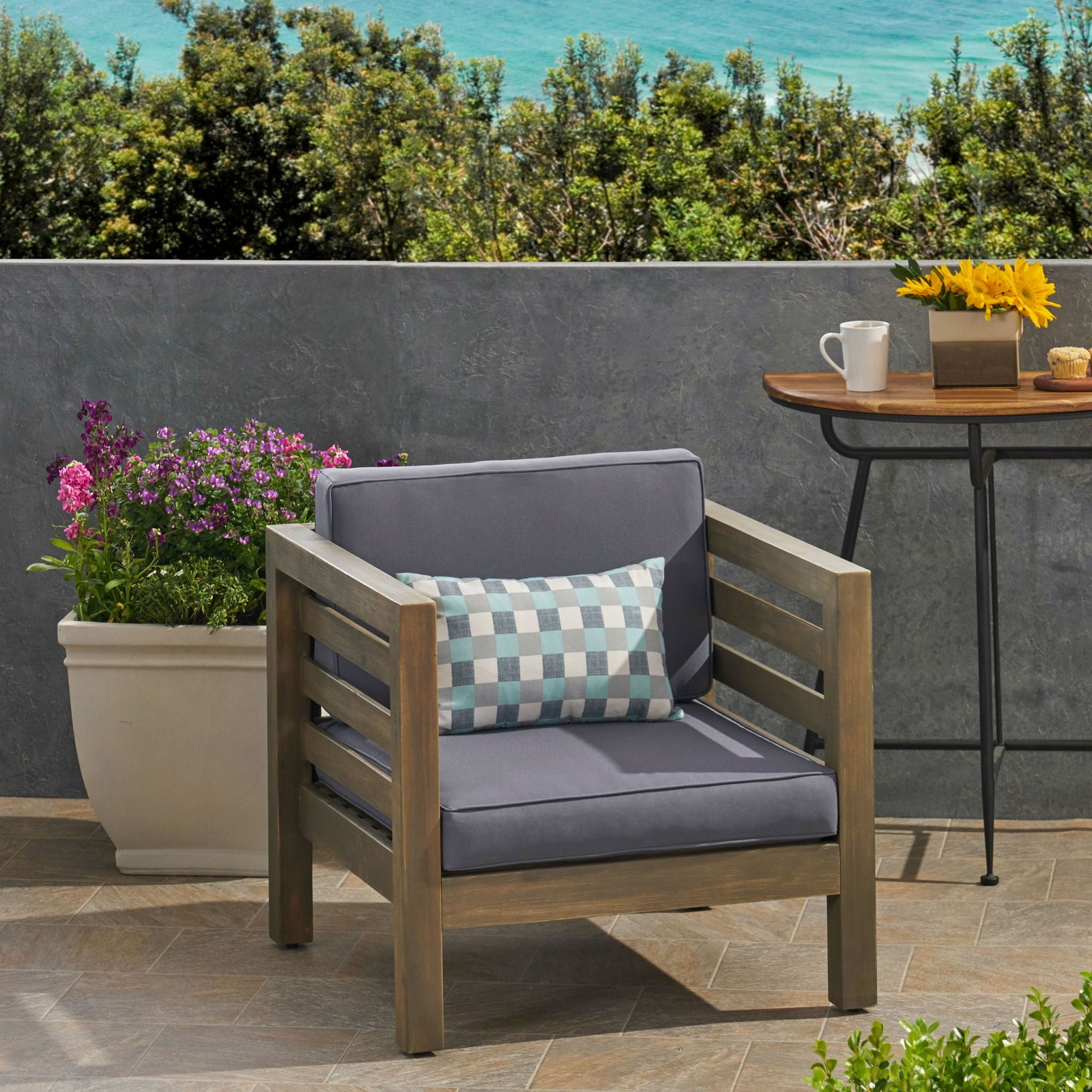 Outdoor acacia wood arm chair with dark fabric cushion by HouseOfZazla on Tampa Home & Garden Store