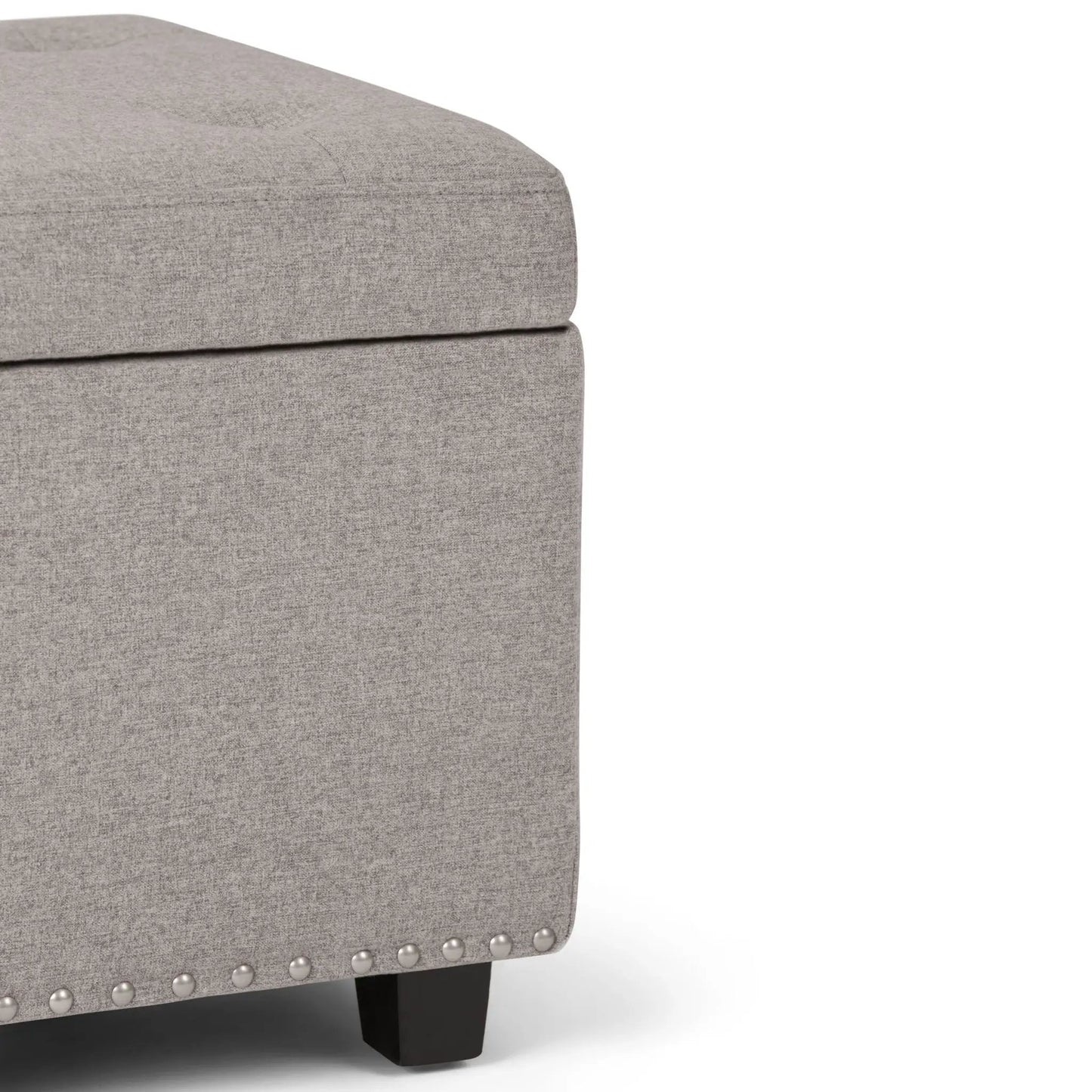 Hamilton upholstered storage ottoman in gray fabric with nailhead trim and dark wood legs on Tampa Home & Garden Store
