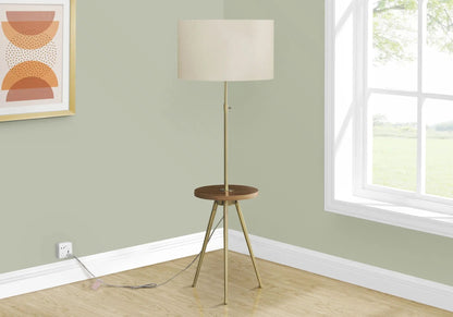 Floor lamp by Unique Piece Furniture with brass tripod and beige drum shade in a sage green room on Tampa Home & Garden Store