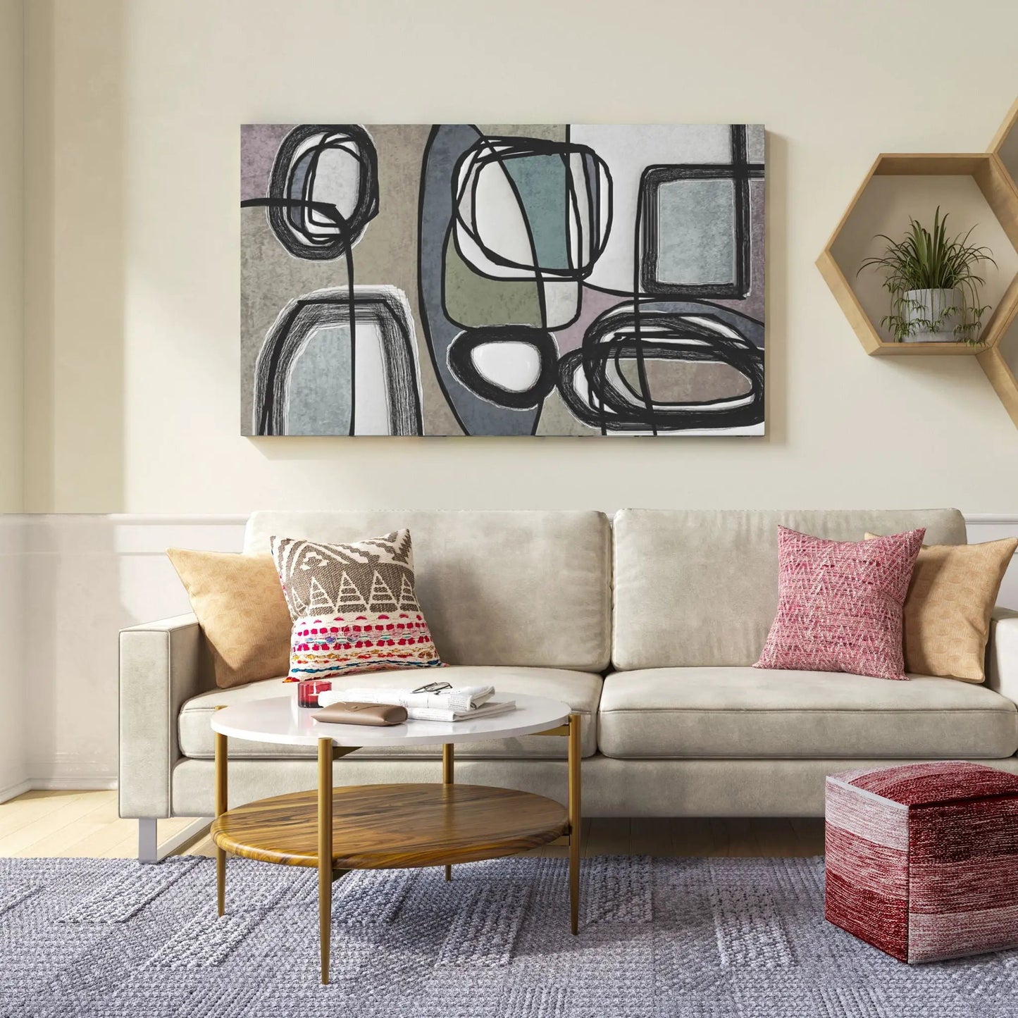 Two round wood-top coffee tables with gold legs in front of a beige sofa and abstract wall art on Tampa Home & Garden Store