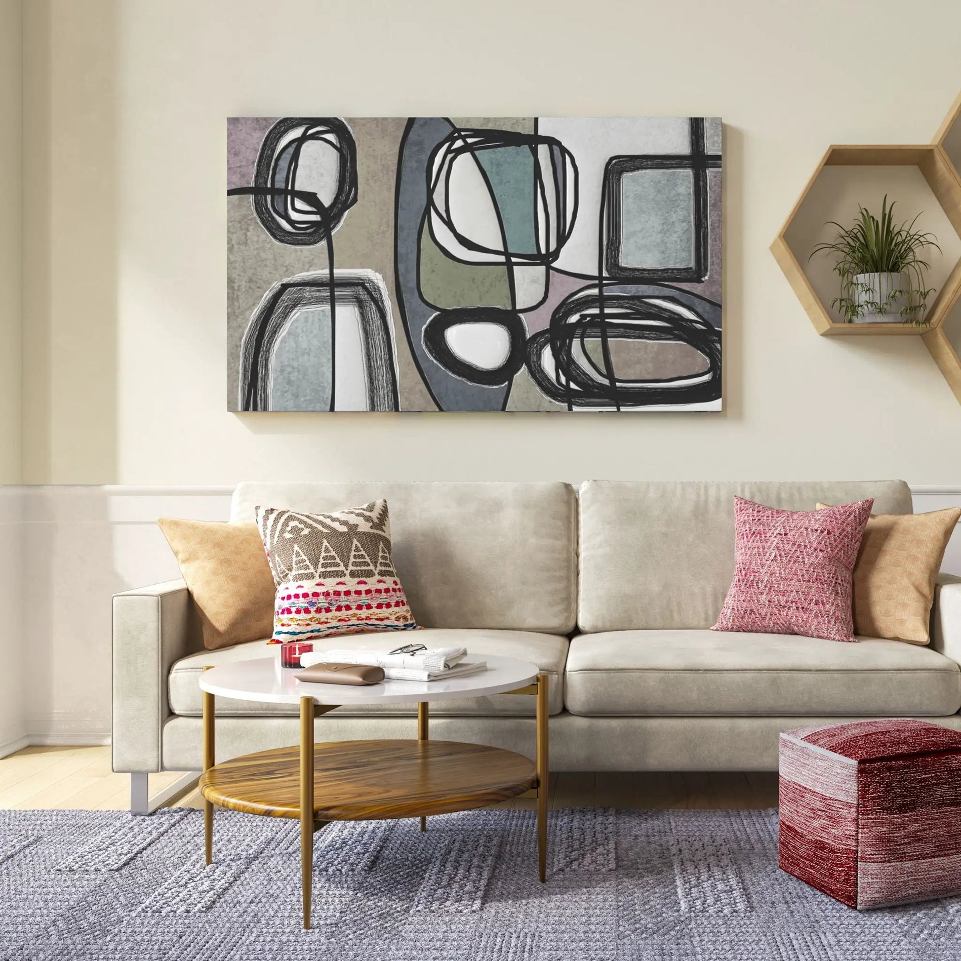 Two round wood-top coffee tables with gold legs in front of a beige sofa and abstract wall art on Tampa Home & Garden Store