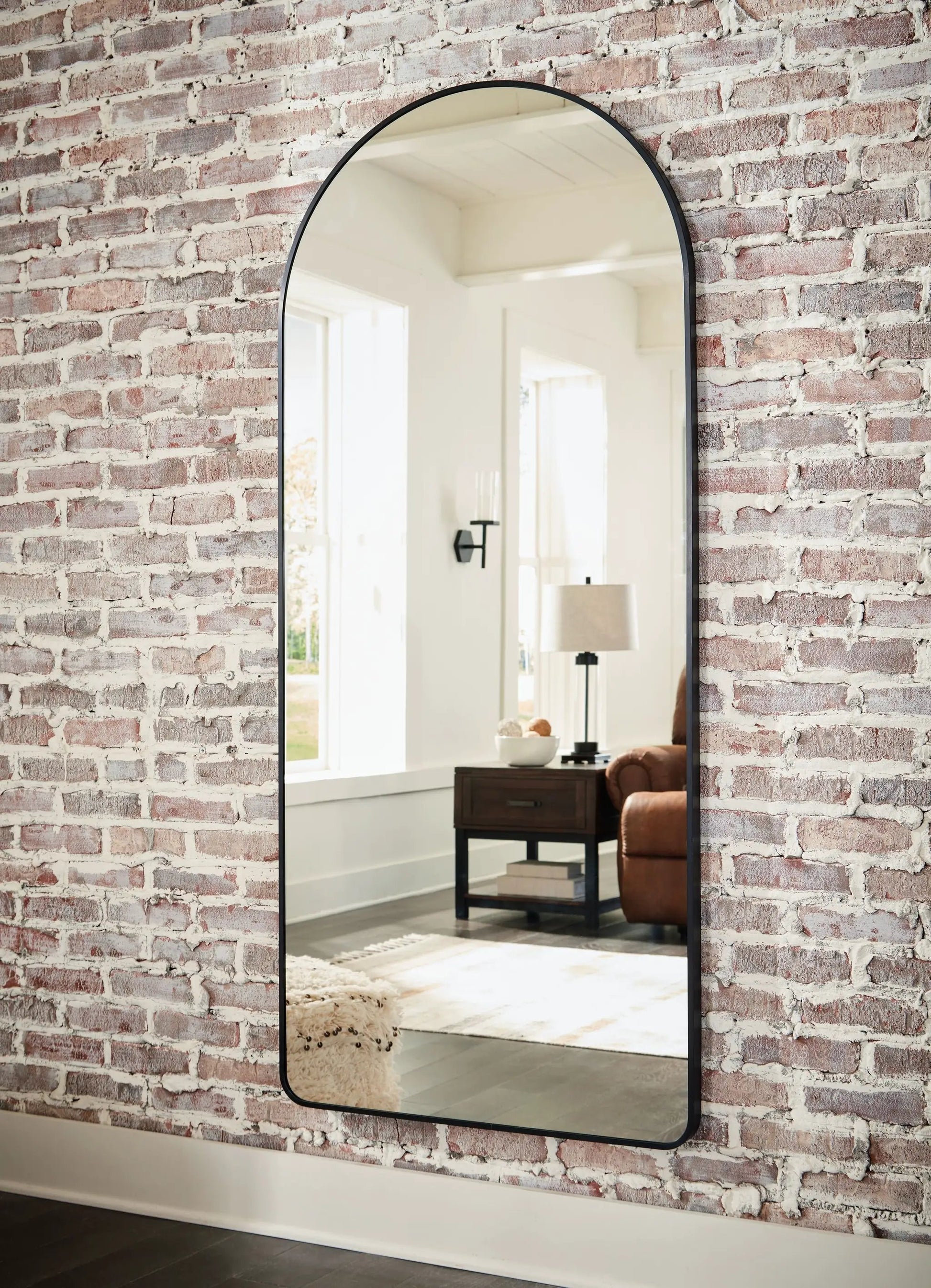 Floor mirror Sethall Black by Unique Piece Furniture, arched full-length black frame on brick wall on Tampa Home & Garden Store