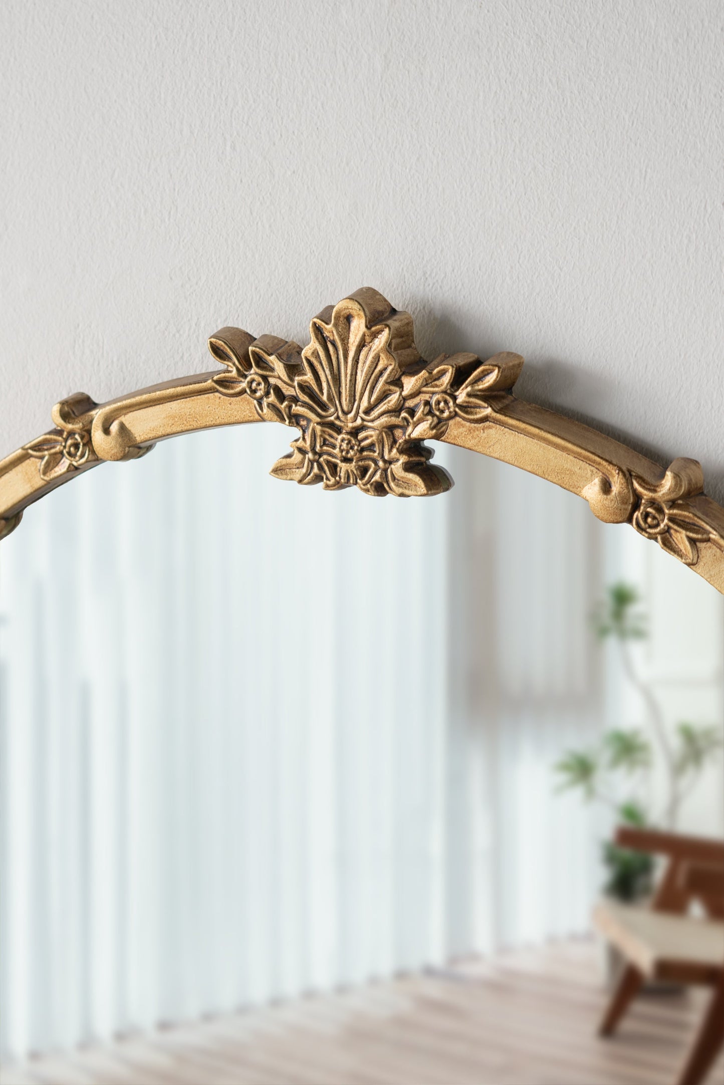 Round wall mirror with gold finish and decorative leaf crest, 30x31 in on Tampa Home & Garden Store