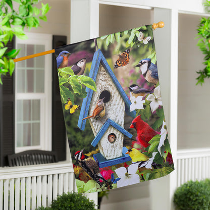 Summer Song Suede House Flag with vibrant birds and butterflies on a wooden rod on Tampa Home & Garden Store