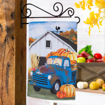 Barns & Harvest Suede Garden Flag on a wrought-iron bracket with a blue truck and pumpkins on Tampa Home & Garden Store