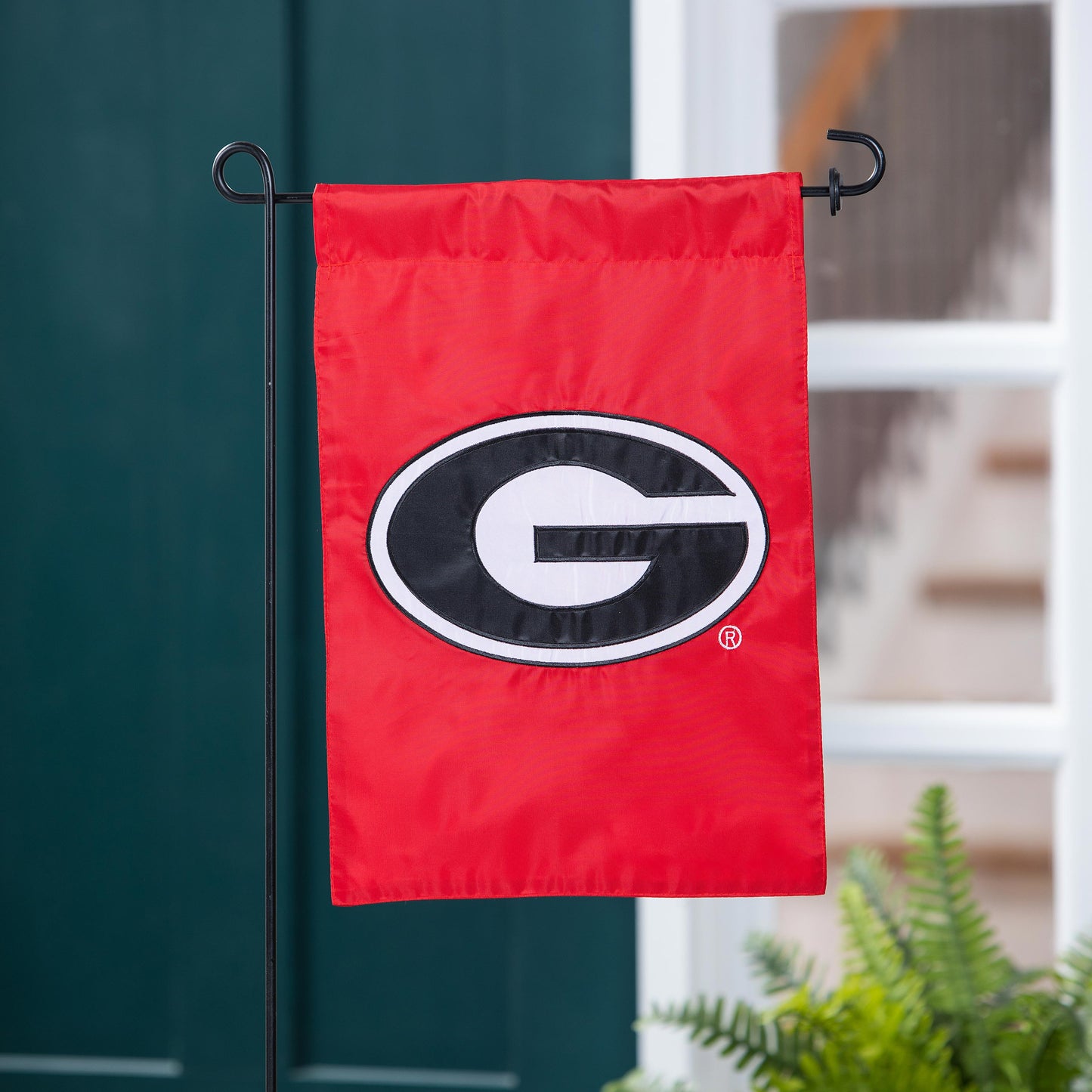 University of Georgia red applique garden flag with G emblem on a black metal stake on Tampa Home & Garden Store