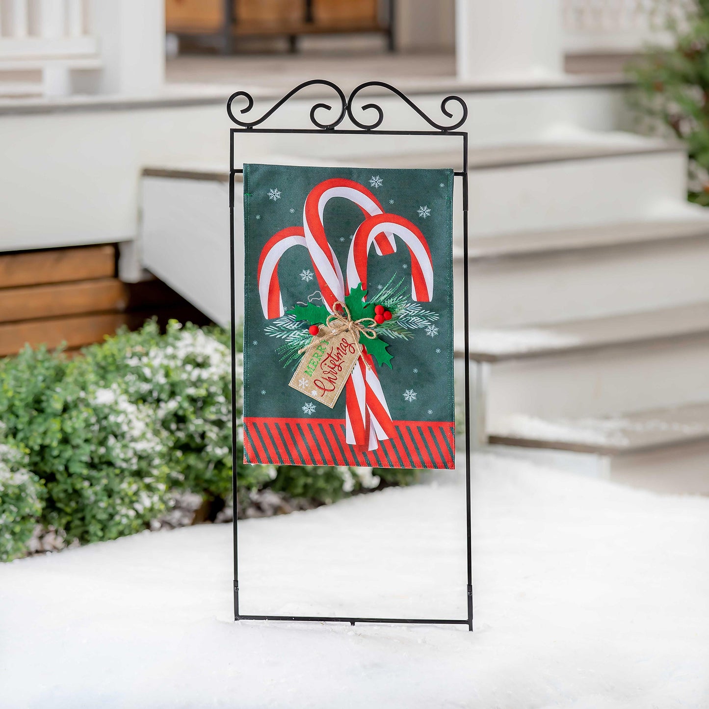 Candy Cane Burlap Garden Flag on metal stake with candy canes, holly and bow on green background on Tampa Home & Garden Store