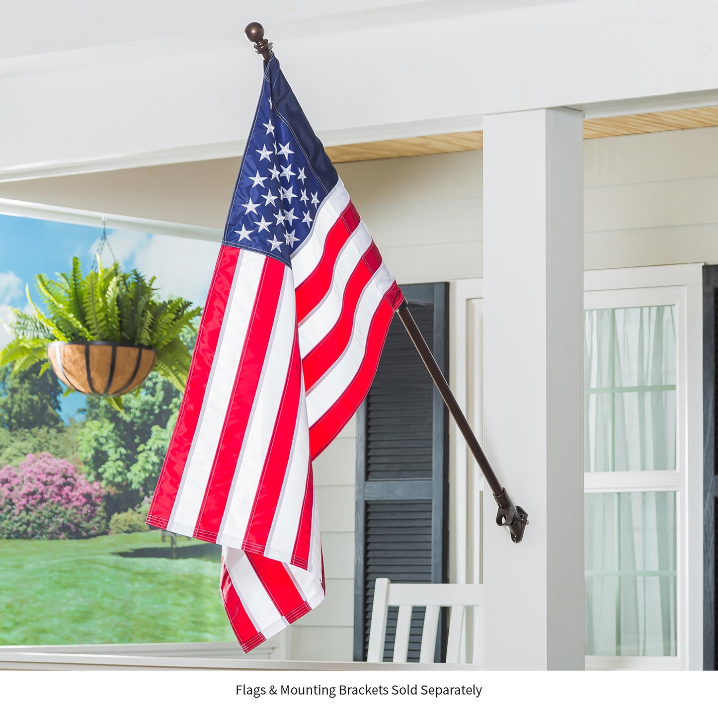 Extendable metal flag pole with brown ball finial holding an American flag in a home setting on Tampa Home & Garden Store