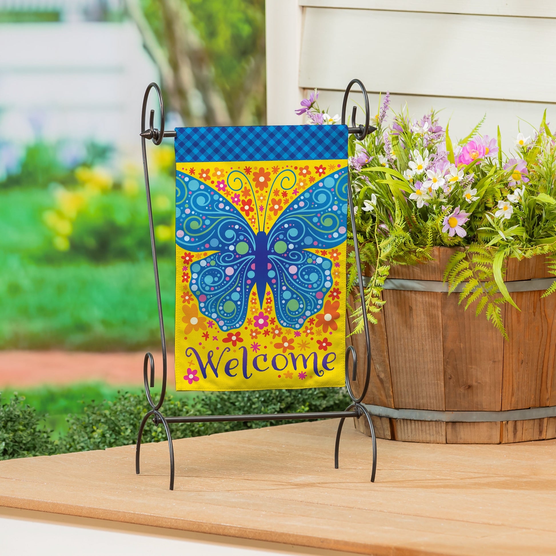 Welcome Mosaic Blue Butterfly Burlap Garden Flag on a metal stand with blue diamond-pattern top on Tampa Home & Garden Store