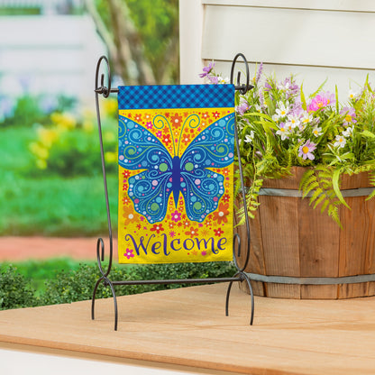Welcome Mosaic Blue Butterfly Burlap Garden Flag on a metal stand with blue diamond-pattern top on Tampa Home & Garden Store