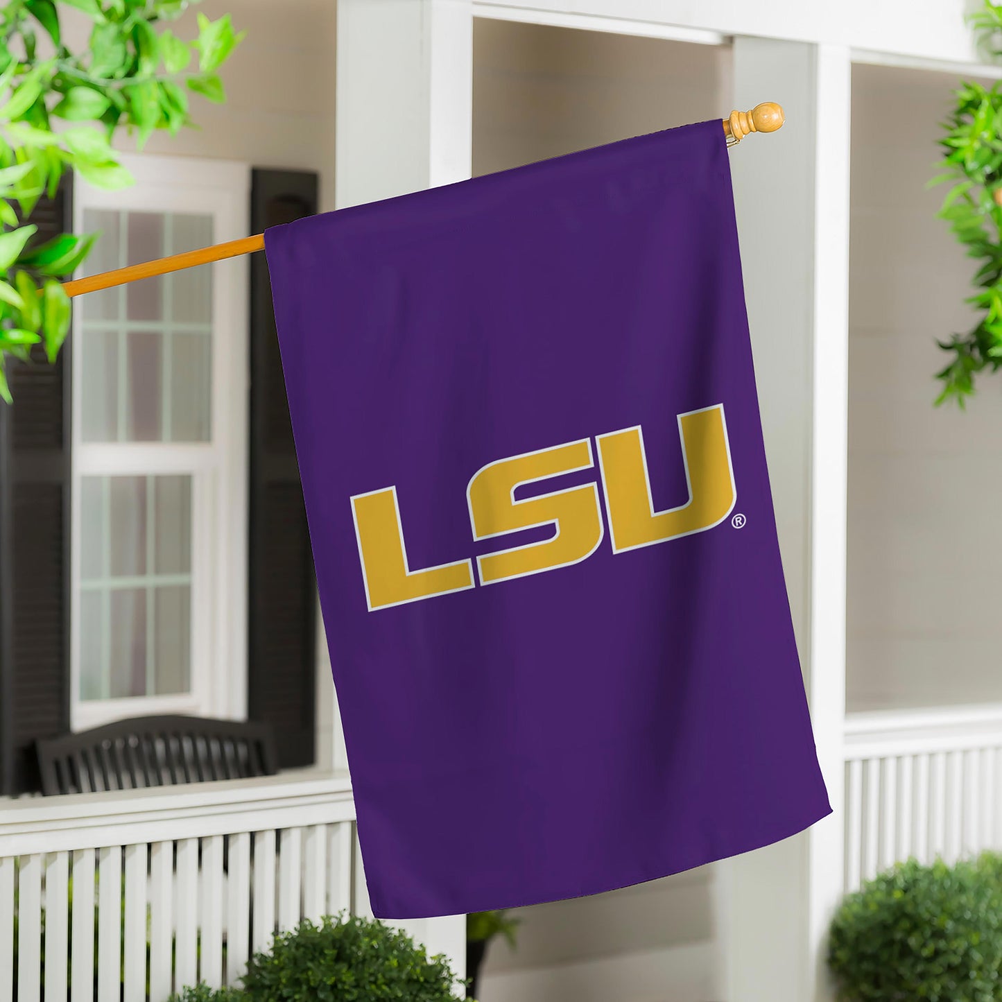 Louisiana State University applique flag in purple with gold LSU letters on wooden pole on Tampa Home & Garden Store