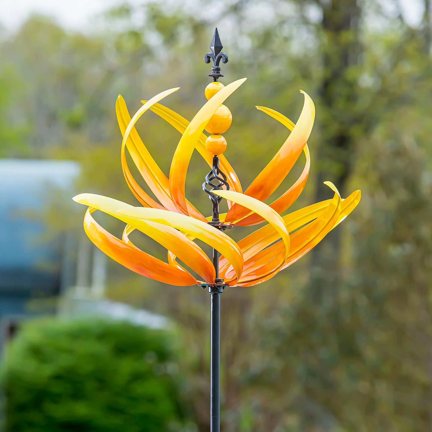 91-inch wind spinner Yellow Lotus with bright yellow blades and black fleur-de-lis finial on Tampa Home & Garden Store