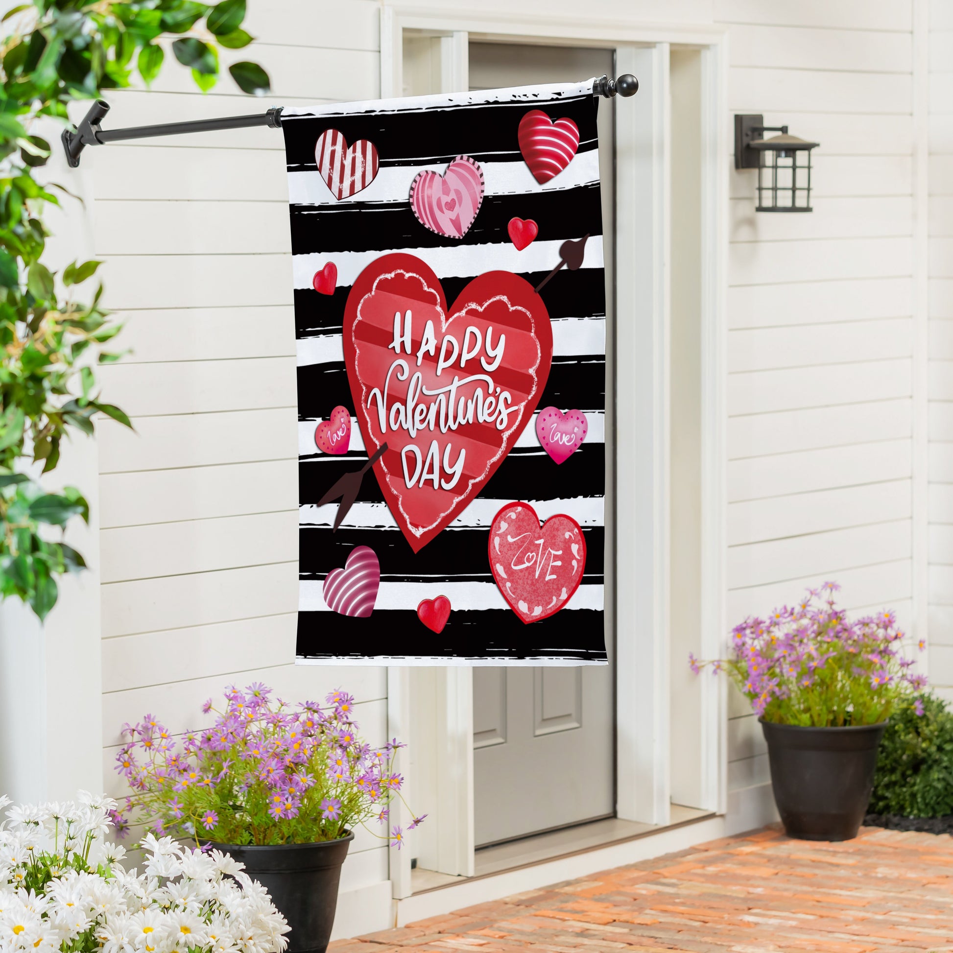 Striped Hearts Burlap House Flag with black and white stripes and red hearts on display on Tampa Home & Garden Store