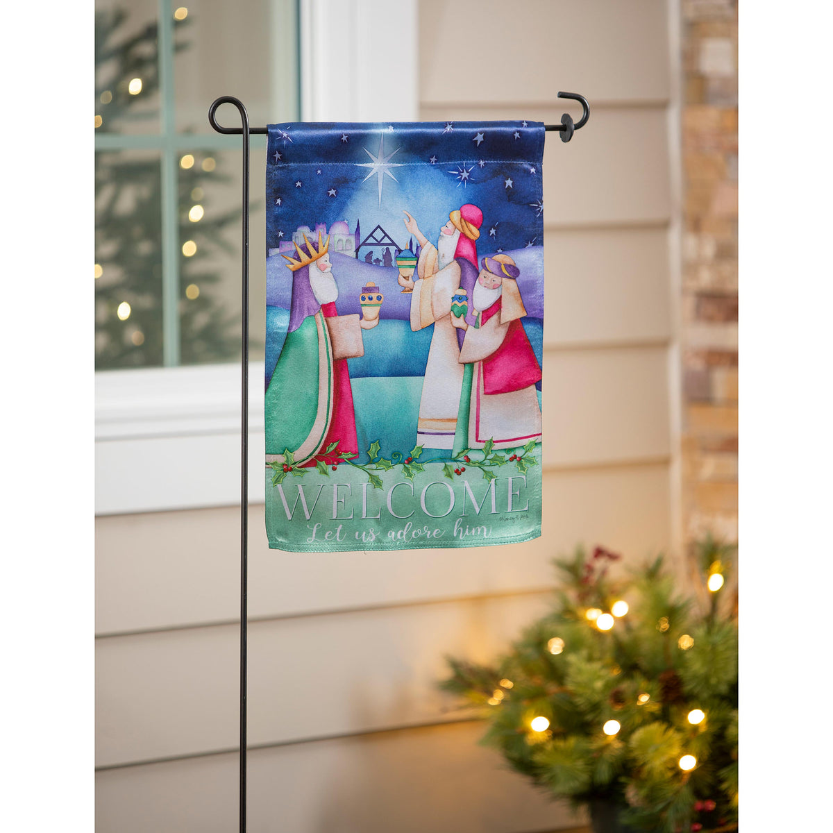Let Us Adore Him Lustre Garden Flag nativity under starry blue sky with holly border on Tampa Home & Garden Store