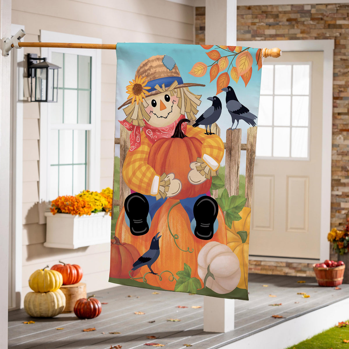 Friends & Scarecrow Suede House Flag with pumpkin, scarecrow, two crows and leaves on porch on Tampa Home & Garden Store